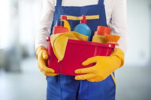 man holding cleaning supplies